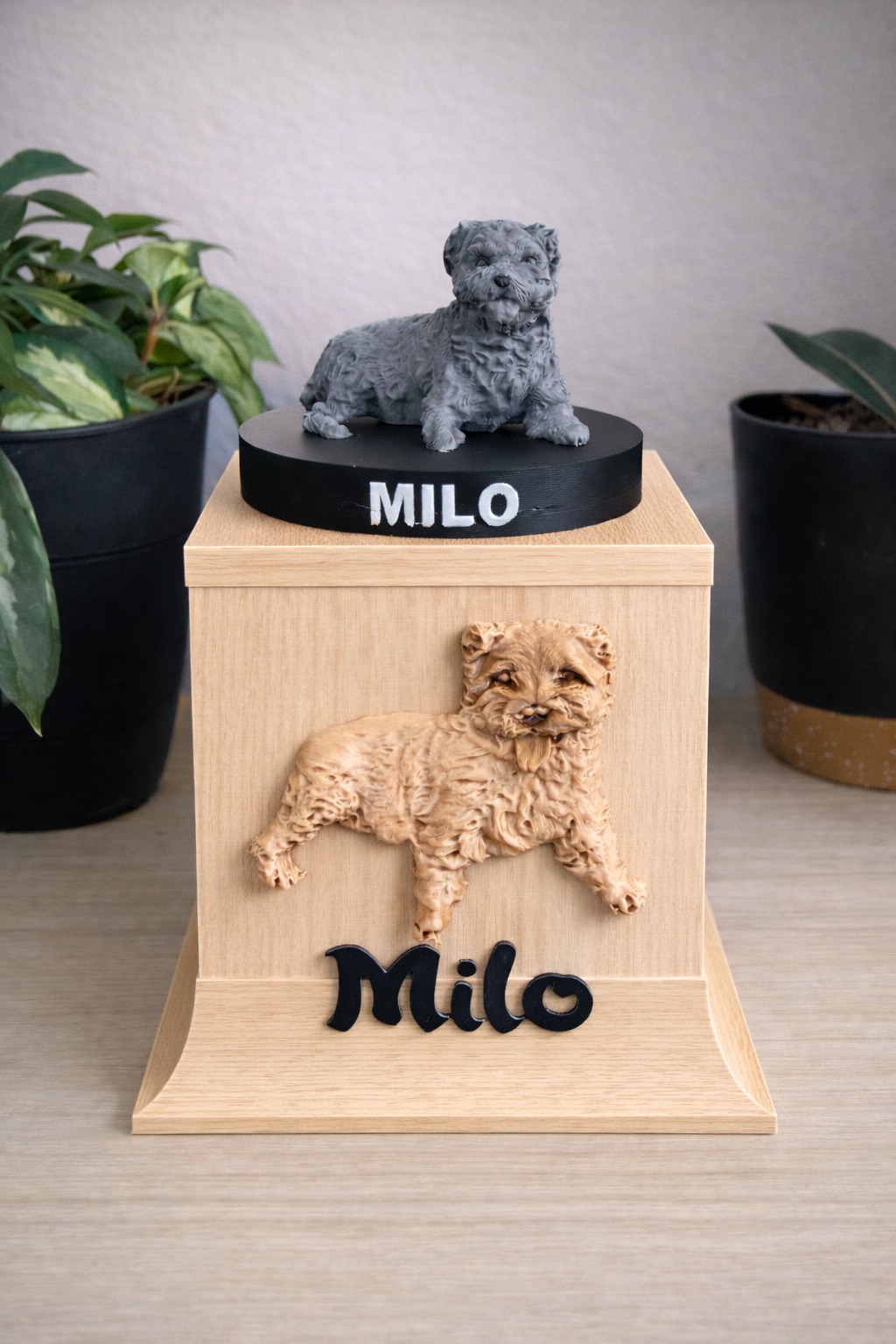 Light oak memorial urn with grey sculptural tribute displayed in a neutral home space